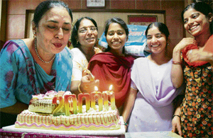 Investors and brokers in Bhopal cut a cake to celebrate the 20,000 mark reached by the Sensex.