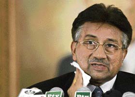Pervez Musharraf wipes perspiration off his face during a news conference in Islamabad