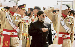 Pakistan's caretaker prime minister Mohammadmian Soomro (centre) reviews a guard of honour in Islamabad on Friday.