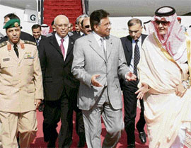 Saudi foreign minister Prince Saud-al-Faisal (R) welcomes Pakistan President Pervez Musharraf (C) on his arrival at Riyadh airport on Tuesday.