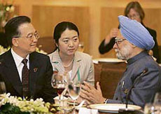 Chinas Premier Wen Jiabao speaks with Prime Minister Manmohan Singh during the working lunch for the East Asia Summit heads of government on the sidelines of the 13th Association of South East Asia Nations Summit in Singapore on Wednesday.