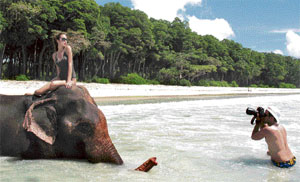 Model Tamaara Moss atop elephant Rajan in the Andamans.