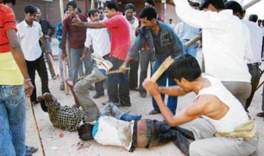 Tribal protesters being beaten up after activists of the All-Adivasi Students Association of Assam (AASAA) clashed with local residents in Guwahati