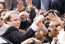 Pakistani opposition leader Nawaz Sharif meets his supporters at Islamabad International Airport on Monday.