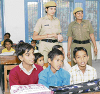 Recruits at the Haryana Police Academy in Madhuban teach slum children as part of their curriculum and (right) recruits take part in the monthly shramdan programme