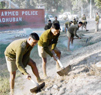 Recruits at the Haryana Police Academy in Madhuban teach slum children as part of their curriculum and (right) recruits take part in the monthly shramdan programme