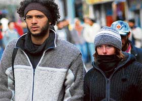 Wrapped fully in woollens, a couple tries to beat cold at Shimla