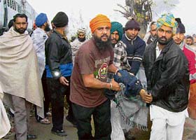 People from nearby areas carry the injured to the nearest hospital in Moga