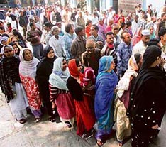 Voters queue up at a polling booth in Ahmedabad on Sunday.