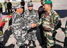 A handout picture released by the defence ministry shows Brigadier D.D. Dadwal (right), contingent Commander of the Indian troops, shaking hands with Senior Colonel Tian of the Peoples Liberation Army of China