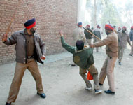 A student under police attack during a protest on the ITI campus in Bathinda, Thursday.