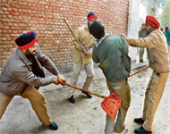 A student under police attack during a protest on the ITI campus in Bathinda, Thursday.