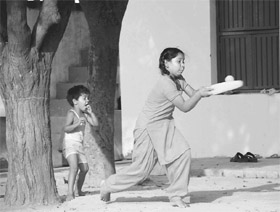 Sporting fervour pervades the entire region and villages are no exception. A Khuda Jassu opener hits out as her younger brother cheers on.
