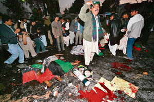 Bodies lie at the site of the election rally addressed by Benazir Bhutto