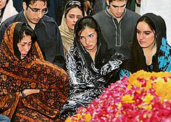Daughters of Pakistans former Prime Minister Benazir Bhutto, Bakhtawar (right) and Asifa (centre), visit their mothers grave with Bhuttos sister, Sanam (left), and their brother, Bilawal (second from left on top), in Garhi Khuda Bakhsh, near Larkana, on Saturday.