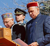 Governor V. S. Kokje administers the oath of office to Prem Kumar Dhumal at The Ridge in Shimla on Sunday.