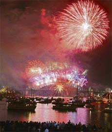 Australians line up the foreshore of the Sydney harbour to usher in the New Year with a spectacular The Time of Your Life firework display