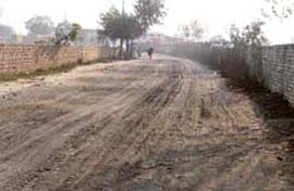 Fly ash gets deposited on a road in Waddi Mundiyan much to the chagrin of residents.