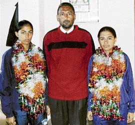 Rupinder Kaur and Sukhvir Kaur with their school principal Moinder Singh who have been selected for World Universities football.