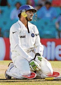 Harbhajan Singh kneels after taking a run on the final day of the second Test against Australia in Sydney