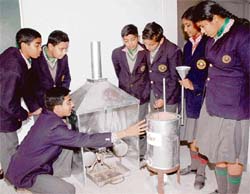 Students of Bhavan Vidyalaya, Panchkula, explain the functioning of an energy-saving chullah and a tandoor.
