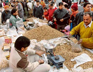People throng vendors selling groundnuts at the Sector 26 market on the eve of Lohri on Saturday.