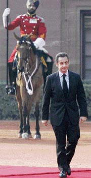 France's President Nicolas Sarkozy reviews troops at Rashtrapati Bhawan on Friday.