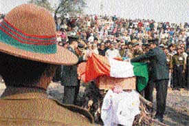 Army officers paying homage to their departed colleague.