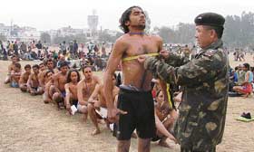 An Army man measures the chest of a youth during the recruitment rally in Ludhiana on Saturday.