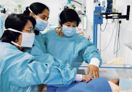 The medical staff with a newborn at the newly commissioned neonatal ICU at the Western Command