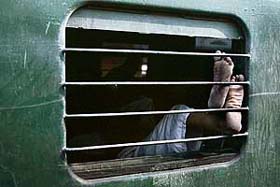 A stranded passenger sleeps inside a train during a 24-hour bandh in Kolkata