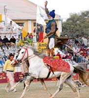 Maggar Singh rides on two horses