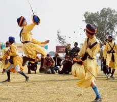 Children perform Gathka at Kila Raipur on Friday.