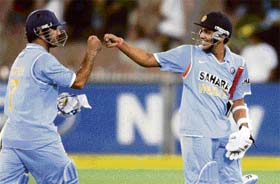 Indian captain M. S. Dhoni (left) congratulates Rohit Sharma after defeating Australia in their one-day encounter at the Melbourne Cricket Ground