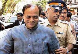 SP leader Abu Azmi is escorted by security persons outside the party's Colaba office in Mumbai