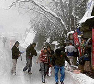 Tourists enjoy snowfall in Shimla.