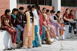 Girl students of Government College, Sector 1, Panchkula, sit in the sun during a free period