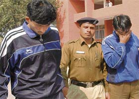 Vijayender Singh and Dinesh Kumar, the security guards of Haryana Raj Bhawan accused of rape, in police custody at the Sector 3 police station in Chandigarh