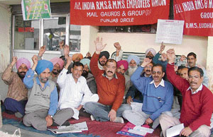 RMS employees hold a dharna at the railway station to press for the acceptance of their demands in Ludhiana on Thursday.