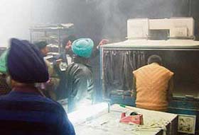 Officials surveying the fire damage at the printing press in Phase VII, Mohali