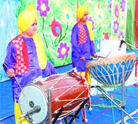 Boys play dhol and nagada, traditional music instruments of Punjab, during a function at SL Bhawan’s School in Amritsar.