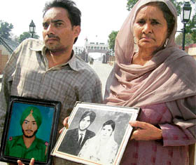 Parmjit Kaur, wife of Indian prisoner Kashmir Singh, along with her physically challenged son Shishupal, at the Attari checkpost on Saturday.