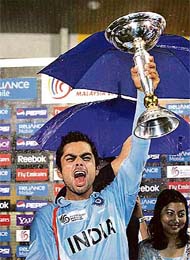 Virat Kohli, captain of the victorious Indian team, holds aloft the trophy after India defeated South Africa in Under-19 World Cup final in Kuala Lumpur