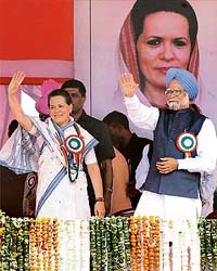 Congress President Sonia Gandhi and Prime Minister Manmohan Singh wave to the crowd at the Dhanyawad-Abhinandan rally at Ramlila ground in New Delhi