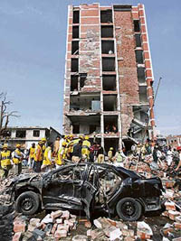 A damaged vehicle outside the offices of Federal Investigation Agencies after a bomb attack in Lahore on Tuesday.