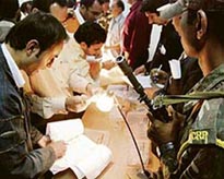 Bidders inspect blue sapphire put on auction in Jammu on Tuesday. 
