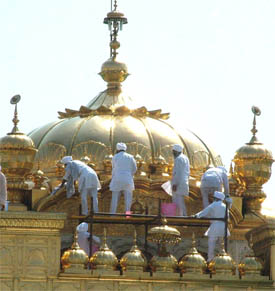 Devotees busy cleaning the Golden Temple.