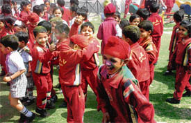 Tiny tots of DAV Mohali school celebrate Holi on Friday.