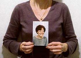 Chantal Sebire holding up a photograph of herself before her illness