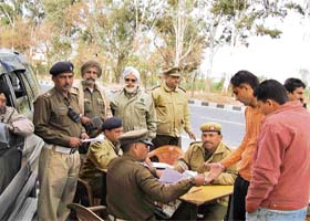 H.S. Puri, general secretary, Ashok Puri Public Road Safety Association, and other members assist the district traffic police in challaning traffic offenders and creating awareness about rules among road users, near Khanpur Kohlia village